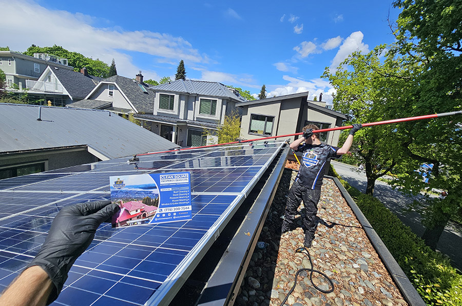 clean squad property services team member washing solar panels in vancouver